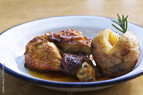 Roast chicken with potatoes on a plate