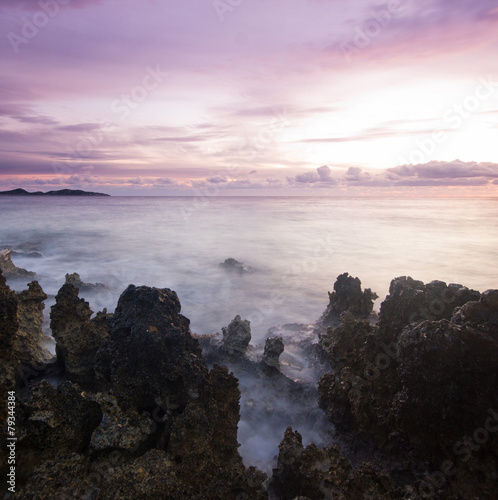 purple sunset on volcanic beach of Mediterranean Sea