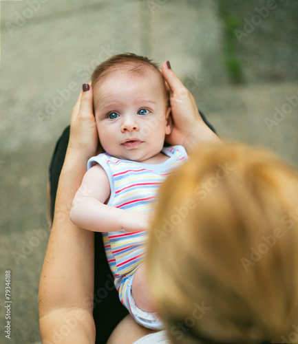 Loving mother holding baby in her lap