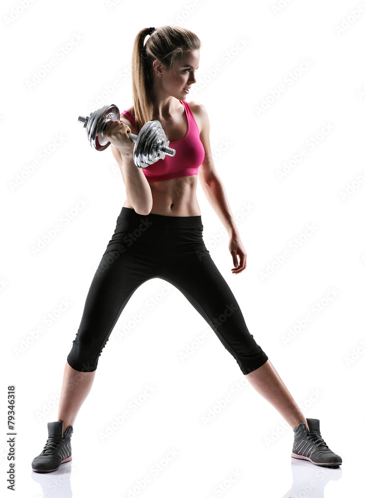 Sporty brunette girl with dumbbell