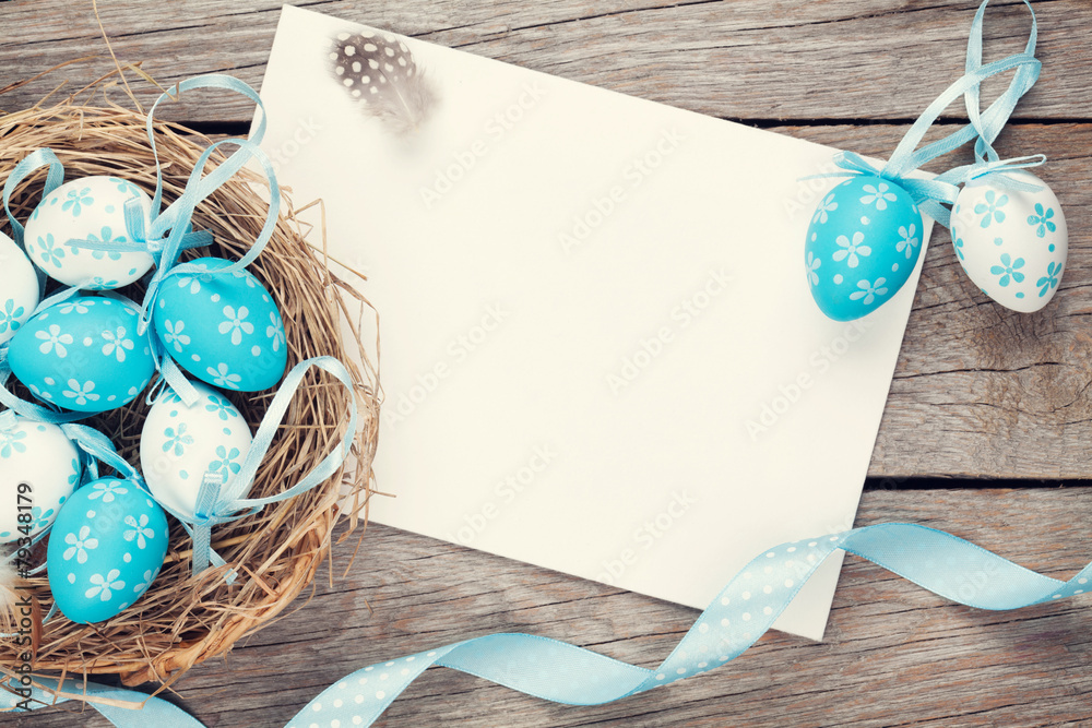 Easter greeting card with blue and white eggs in nest over wood - obrazy, fototapety, plakaty 