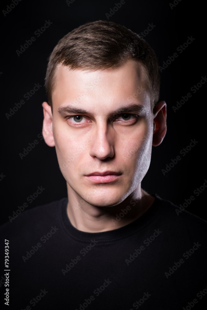 Fototapeta premium Young man on black