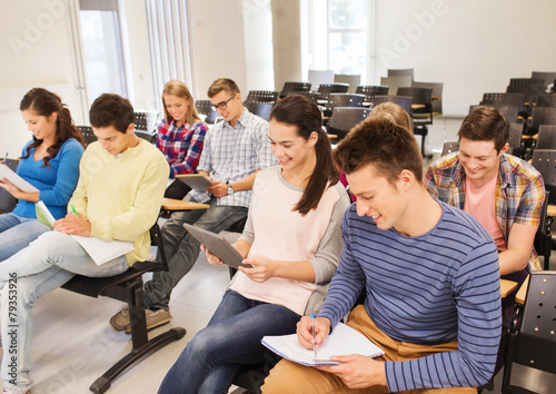 group of smiling students with tablet pc