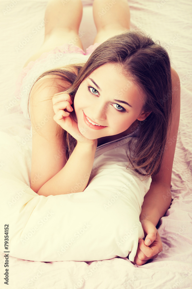 Fototapeta premium Beautiful woman lying on bed.