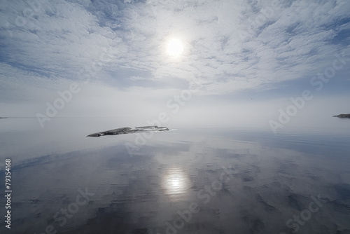 Reflection of the sky in the misty lake.