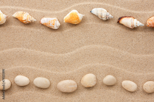 Two rows of stones and shells on the sand