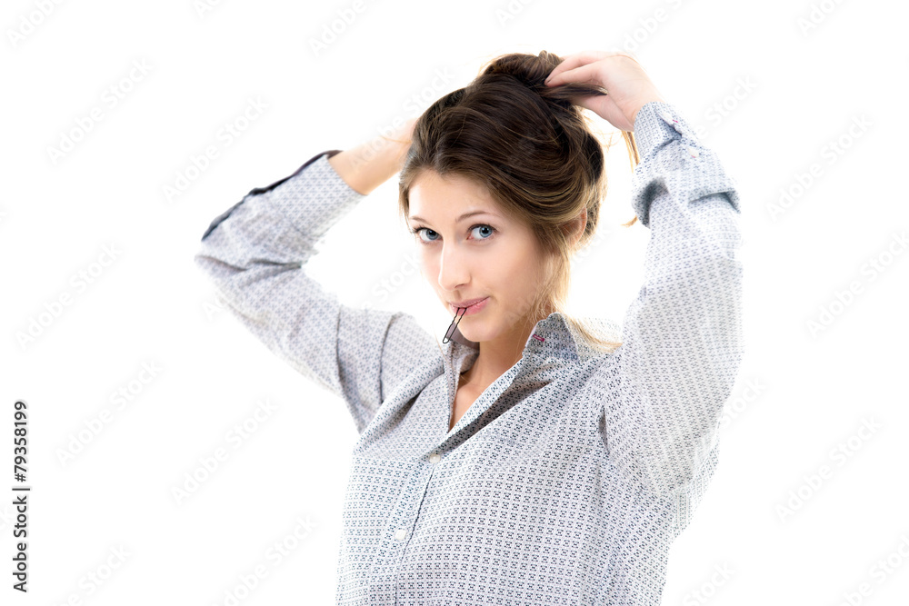 Funny beautiful girl with hairpin in her lips gathering hair up Funny beautiful girl with hairpin in her lips gathering hair up