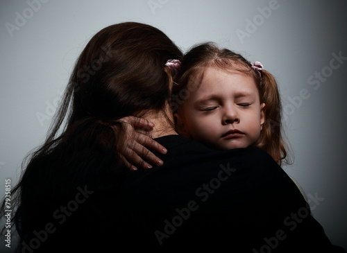 Sad crying daughter hugging her mother with sad face