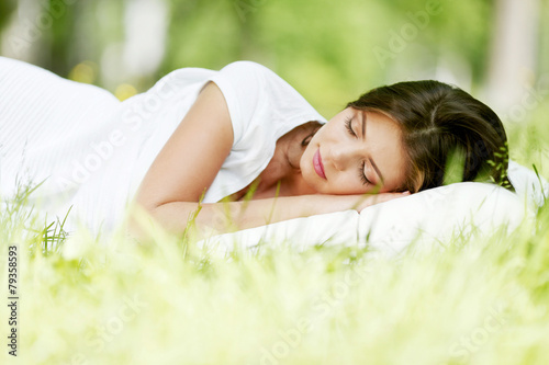 Woman sleeping on grass