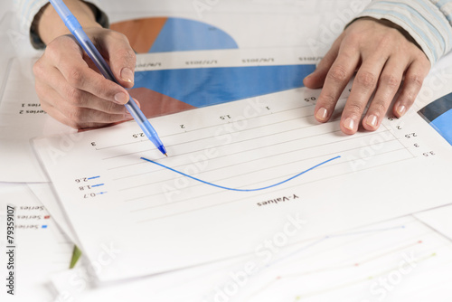 Businesswoman hands analyzing financial statistics.