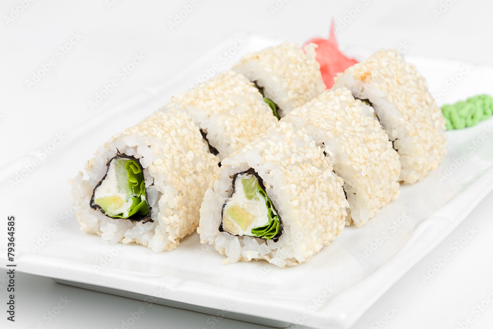 Three-cornered sushi roll with fish, cucumber and green salad. Three-cornered sushi roll with fish, cucumber and green salad.
