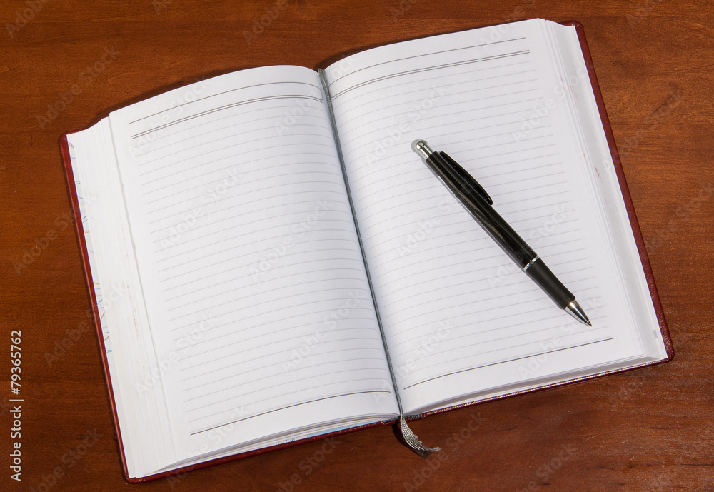 notebook on a wooden table notebook on a wooden table