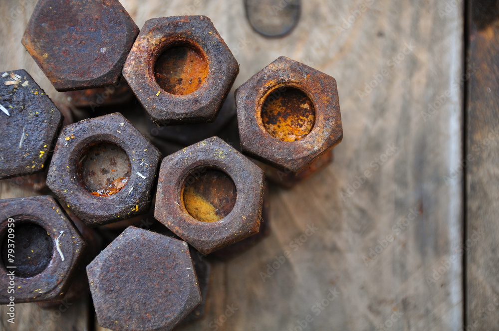 Old bolts or dirty bolts on wooden background Old bolts or dirty bolts on wooden background
