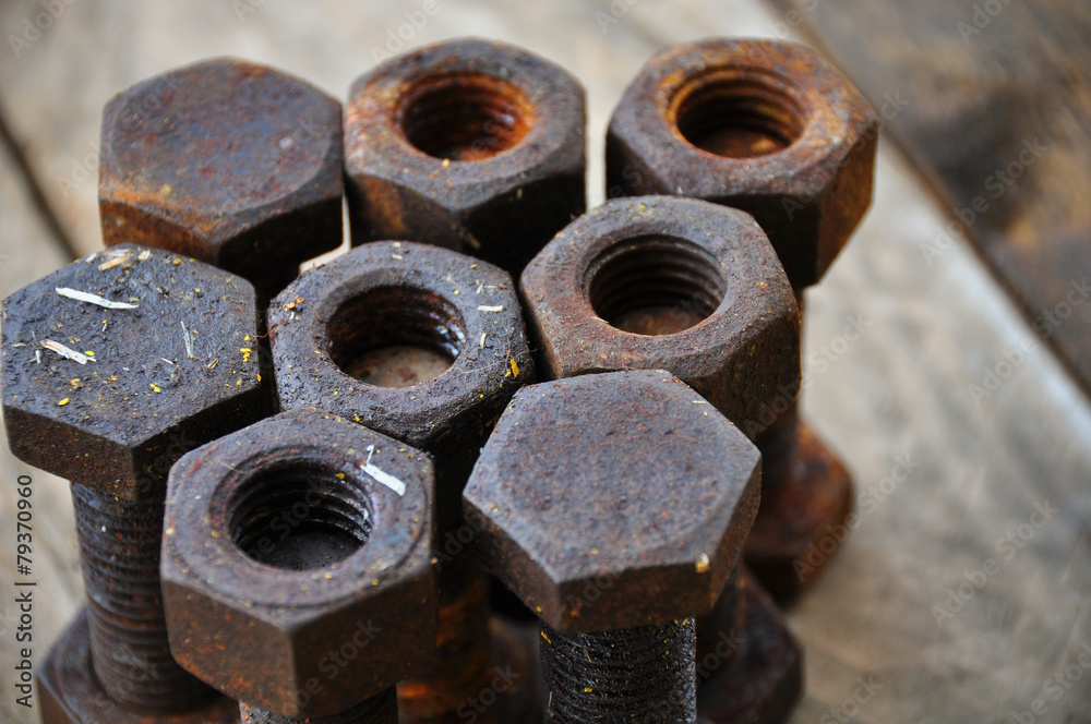 Old bolts or dirty bolts on wooden background Old bolts or dirty bolts on wooden background