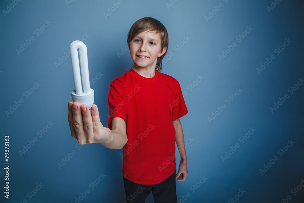 European-looking boy of ten years holding a light bulb on European-looking boy of ten years holding a light bulb on