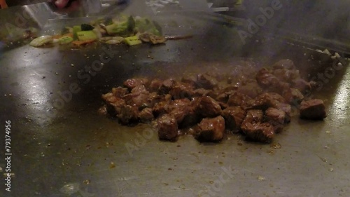 Japanese chef cook preparing Asian food on Teppanyaki grill