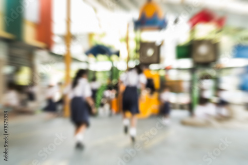 Blurred schoolgirls are playing in the playground