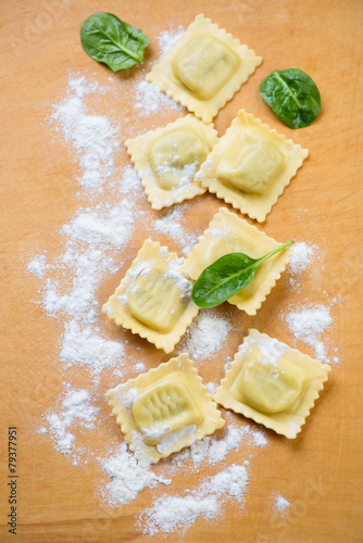 Raw ravioli with ricotta and spinach, above view, studio shot