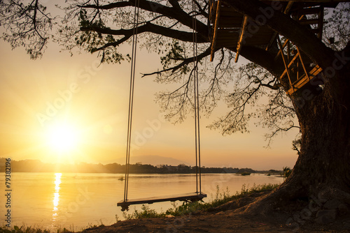 samotna huśtawka po stronie rzeki i zachód słońca, Tajlandia