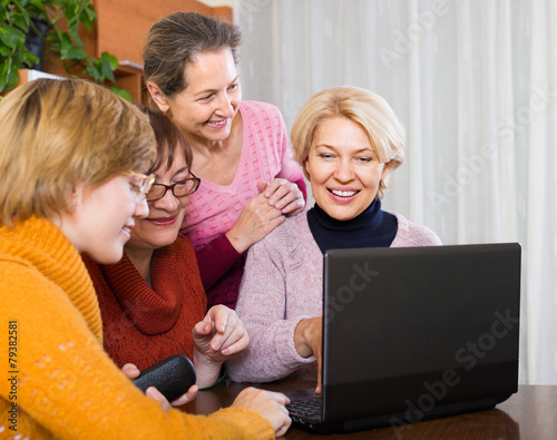 Female pensioners with laptop indoor