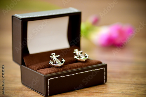 Shirt cufflinks shaped boat anchor placed in support