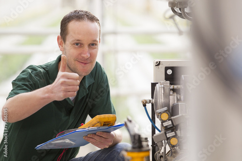 Male technician repairing agriculture machinery