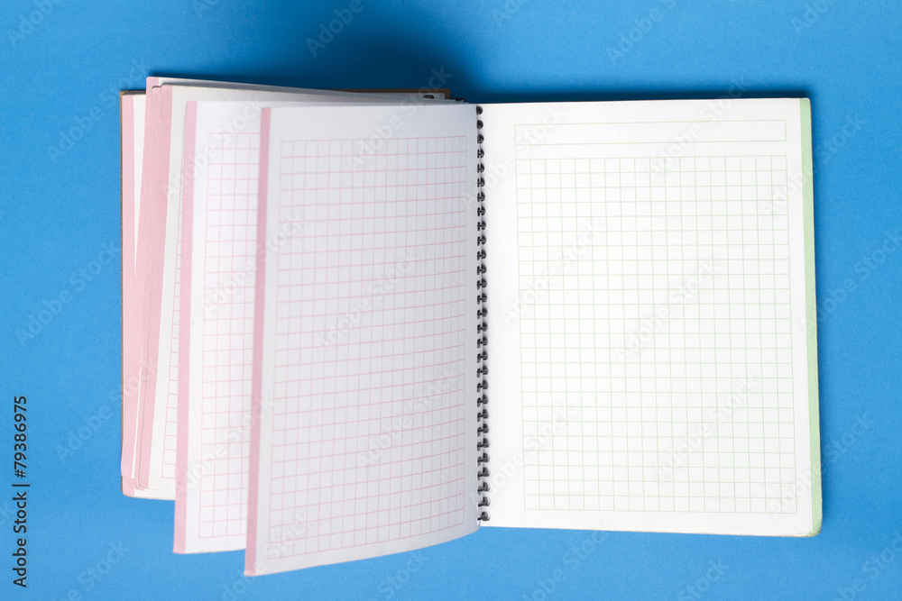 Small notebook over a blue background. Small notebook over a blue background.