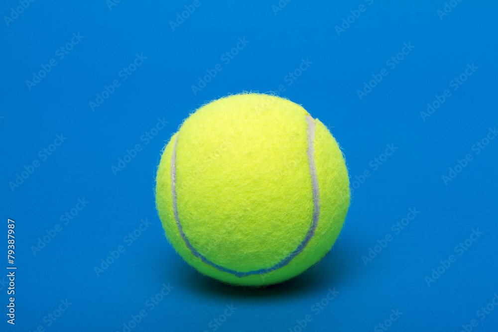 Isolated tennis ball over a blue background.