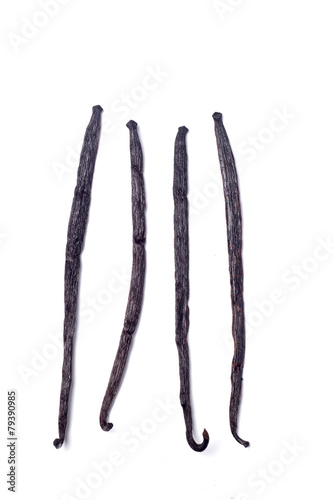 Close view of vanilla pods over a white background.
