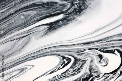 Mix of a white and black paint, closeup.