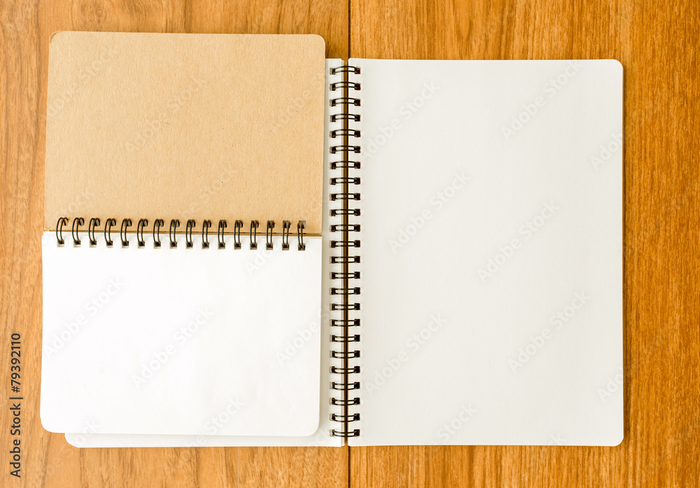 Spiral notebook on wood background Spiral notebook on wood background