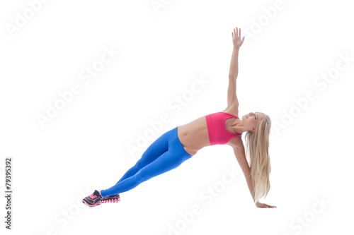 Long-haired female athlete doing pilates exercises