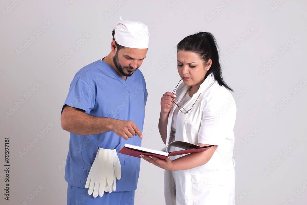 Clinical Team of Woman Doctor and Surgeon Are Reading Patient Di Clinical Team of Woman Doctor and Surgeon Are Reading Patient Di