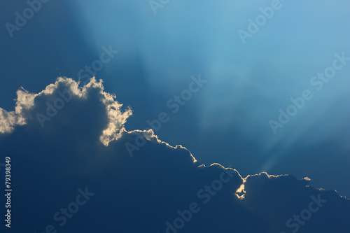 Unusual cloud with a luminous edge and rays of the sun