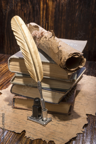 Vintage golden pen and ancient manuscripts