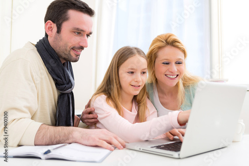 Happy family in front of a laptop