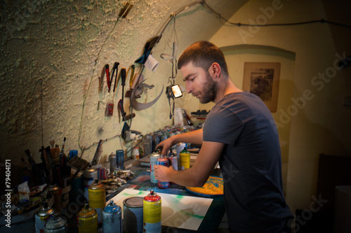 Young artist working in his studio creating artwork