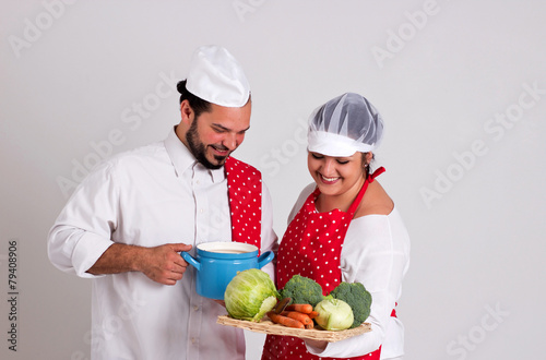 Smiling Italian Chiefcook and Cooky are Preparing Vegetable Soup photo