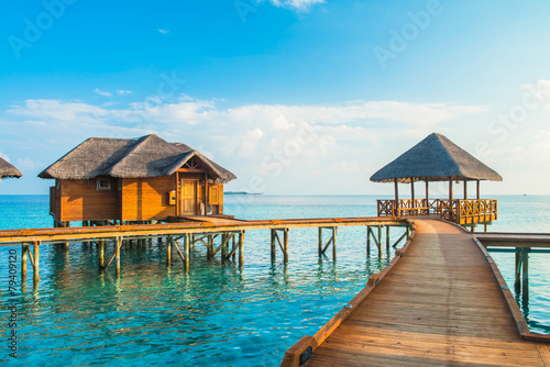 Over water bungalows with steps into amazing green lagoon © theyok