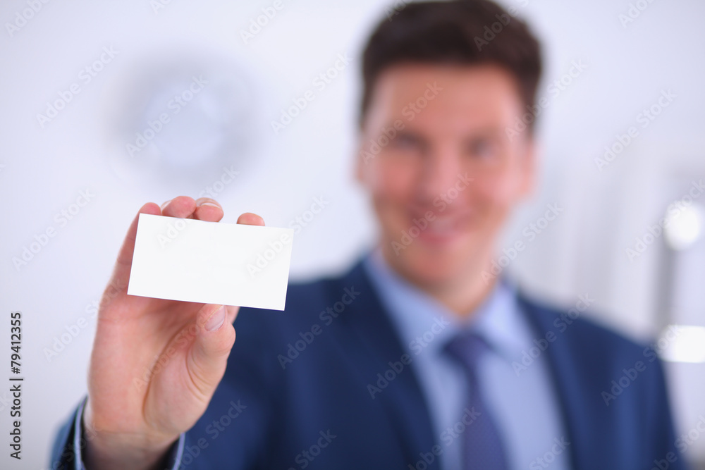 Portrait of young man holding blank white card Portrait of young man holding blank white card