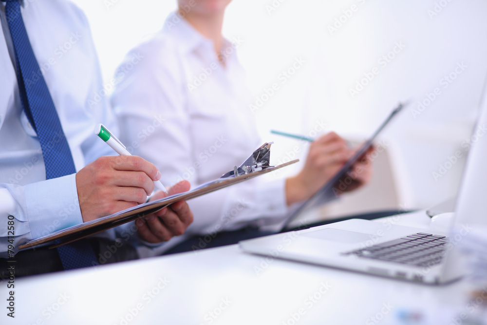 Business people sitting and writting at business meeting, in Business people sitting and writting at business meeting, in