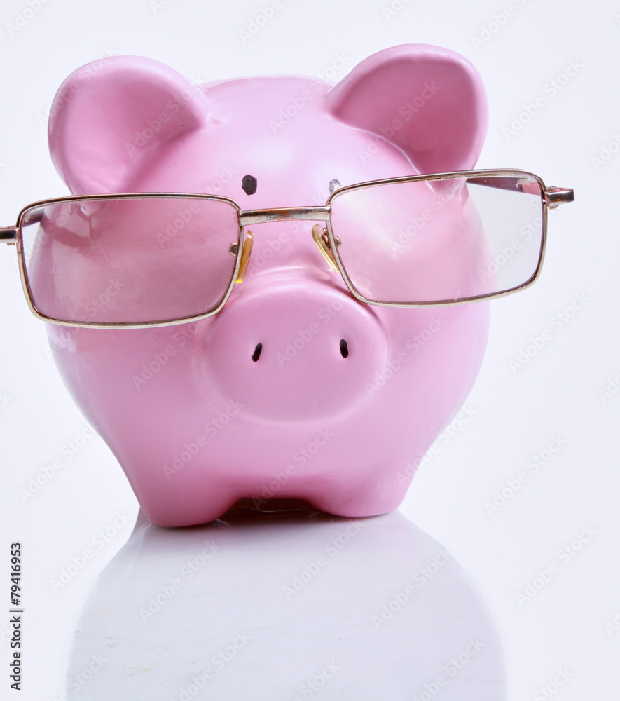 Piggy bank with glasses in isolated white Piggy bank with glasses in isolated white