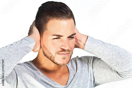 Depressed young man covering ears with hands isolated on white b