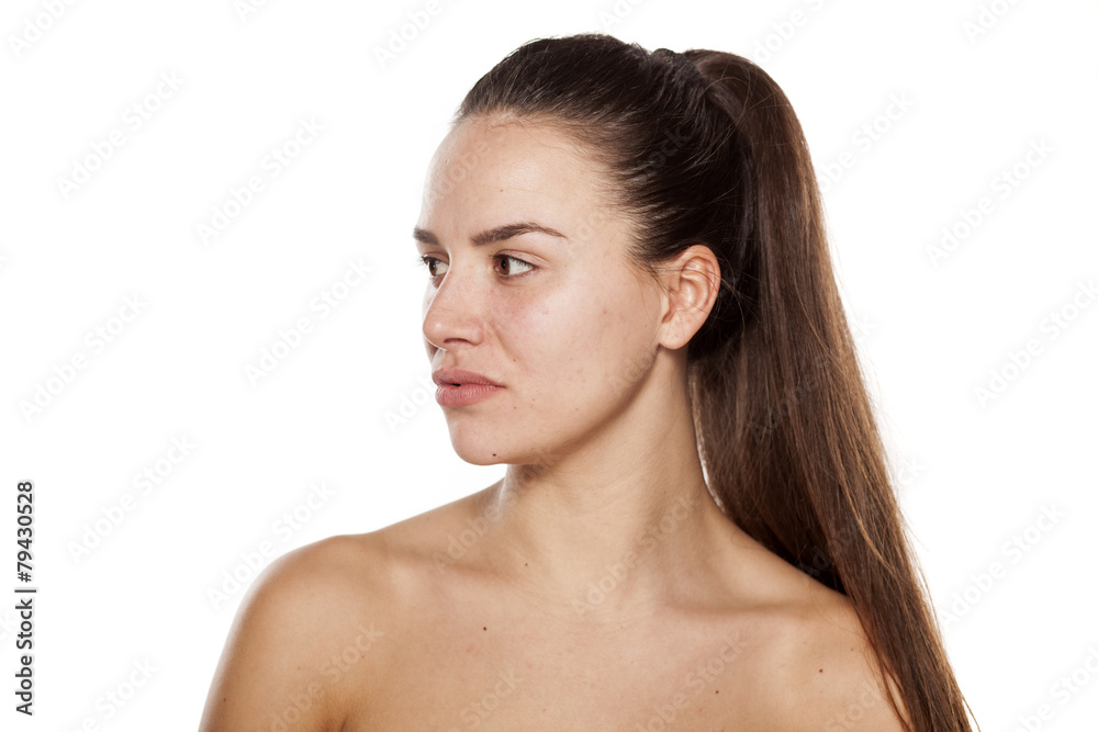 serious young woman without make-up looking to the side serious young woman without make-up looking to the side