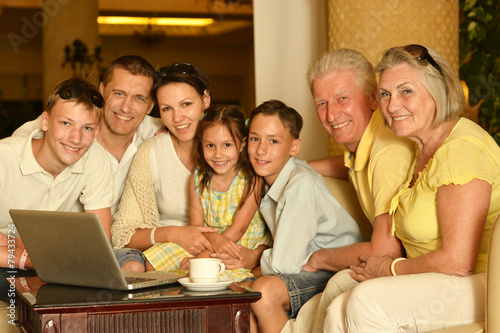family sitting with laptop