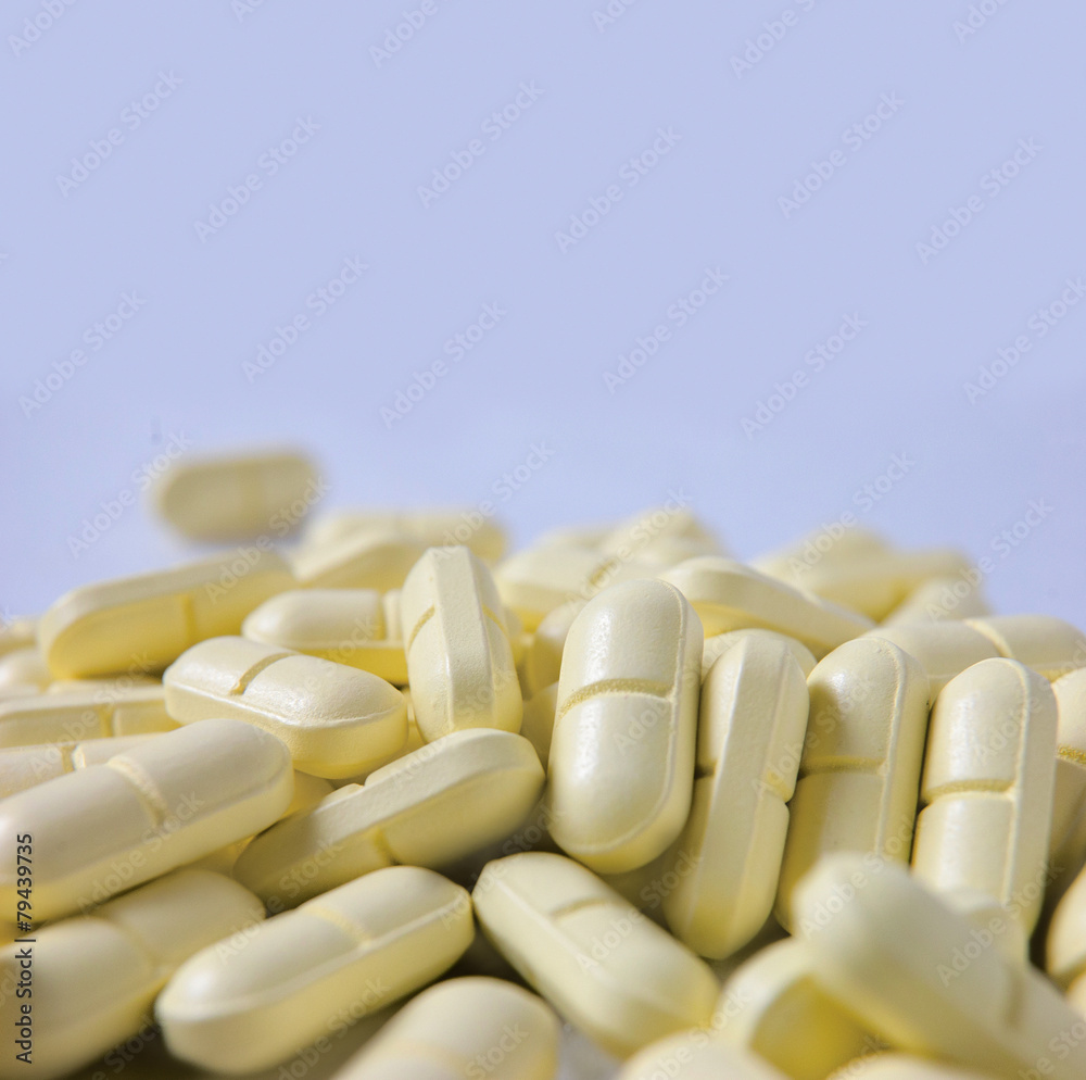 Heap of yellow pills and a lot of copyspace Heap of yellow pills and a lot of copyspace