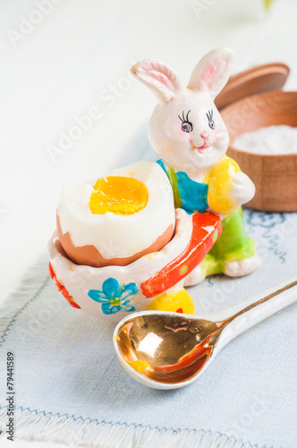 Easter rabbit and egg on white wooden table background