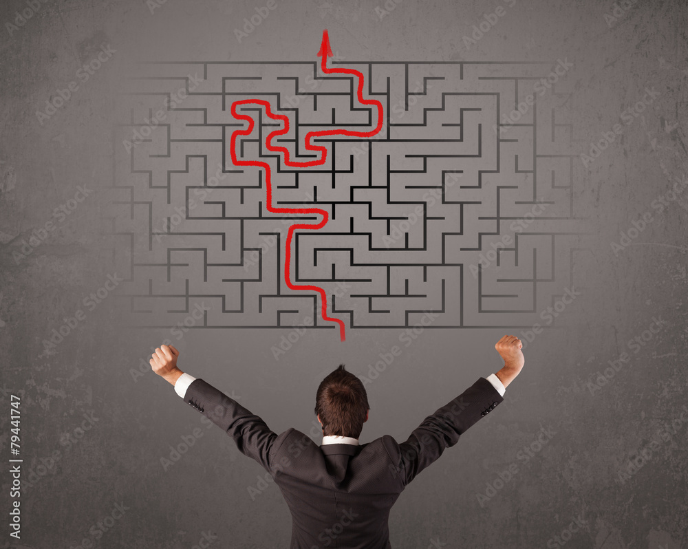 Business man looking at a maze and the way out Business man looking at a maze and the way out