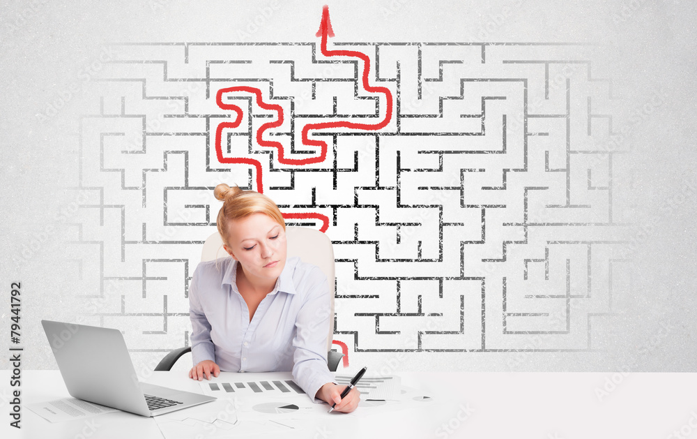 Business woman at desk with labyrinth and arrow Business woman at desk with labyrinth and arrow