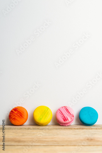 Colorful macaron with white background on wooden floor